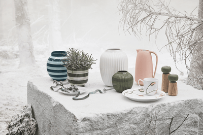 
                    
                      Hammershøi oak and dark ceramic spice grinders, a pair set on snow-covered stone in winter scene.
                    
                  