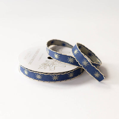 
                    
                      Botanica Paper Co. Stars Embroidered Ribbon, deep blue with gold stars and scalloped trim, full spool with unspooled length.
                    
                  
