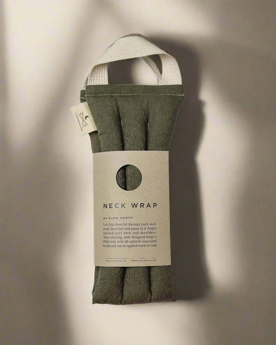 Olive Microwaveable Neck Wrap, cotton and linen blend, folded and packaged with descriptive label, showing cream handle…