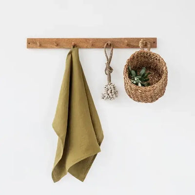 
                    
                      MagicLinen Premium Linen Tea Towel in olive green, 100% linen texture, hanging from a wooden peg.
                    
                  