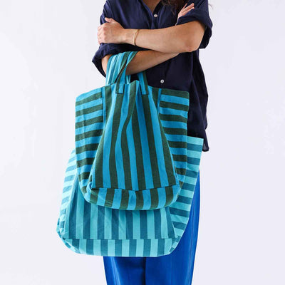 
                    
                      Elisabeth Tote Bag, turquoise and olive stripes, 100% cotton, on person holding it with a smaller matching tote.
                    
                  