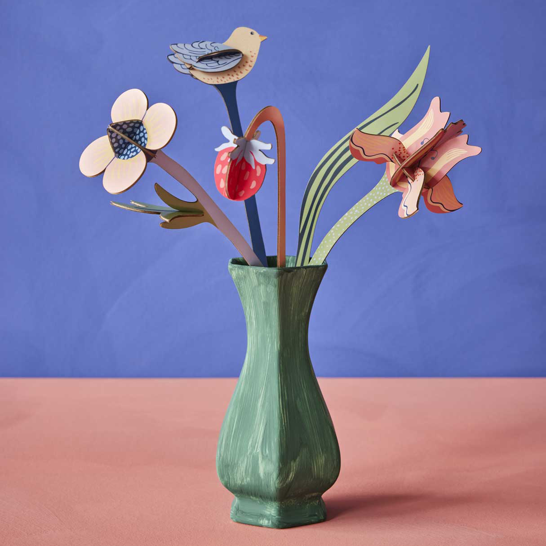 William Morris Bouquet 3D build kit, assembled colorful cardboard flowers, bird, and strawberry in a green vase.