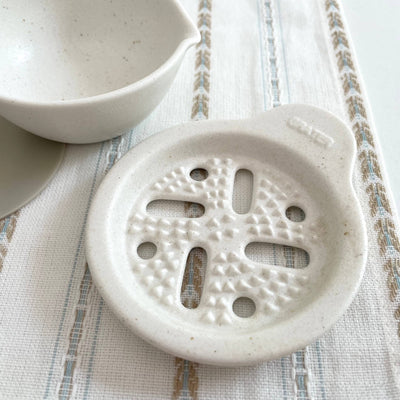 
                    
                      Japanese Ceramic Vegetable Grater, close-up of textured white porcelain grating nubs and "GRATER" embossed detail.
                    
                  