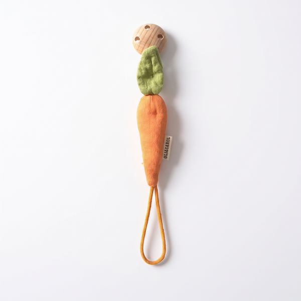 Oli & Carol Cathy the Carrot Pacifier Clip studio product photo on a neutral off-white background