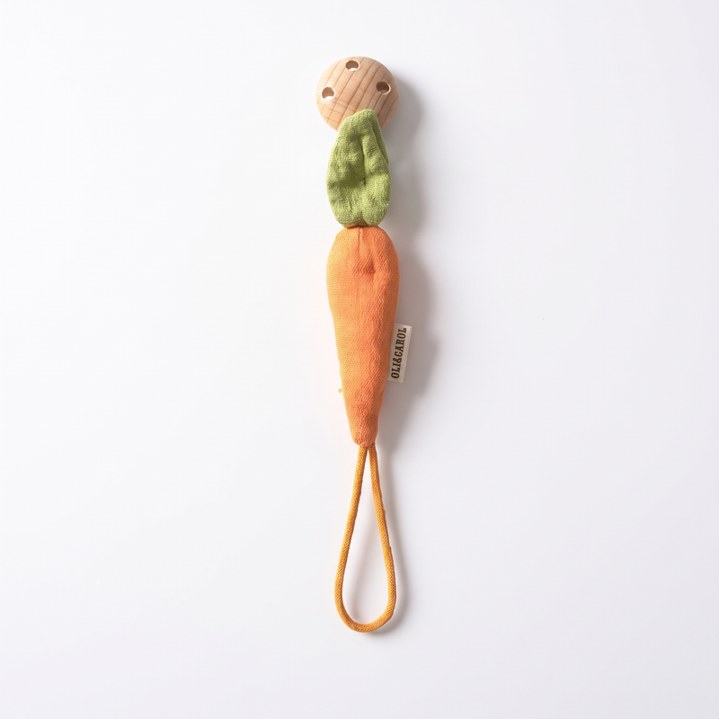 Oli & Carol Cathy the Carrot Pacifier Clip studio product photo on a neutral off-white background