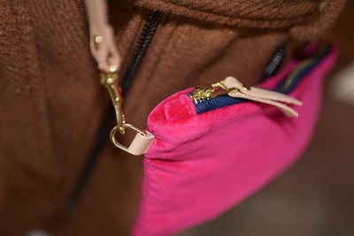 
                    
                      Ellie wristlet, hot pink cotton velvet with navy zipper, natural leather pull and brass clasp detail.
                    
                  
