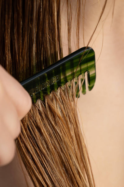 
                    
                      Peignee Paris Travel Wide-Tooth Wave Comb in emerald acetate, detangling wet hair, teeth and wave pattern close-up
                    
                  