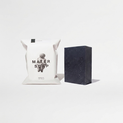 
                    
                      Mater Soap Charcoal Soap Bar, dark grey speckled bar and white paper packaging, front view on white.
                    
                  