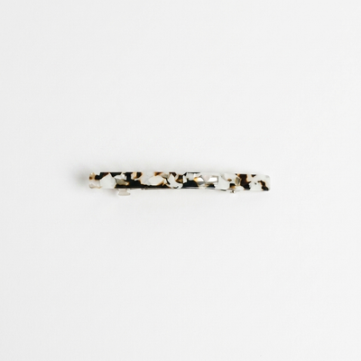 
                    
                      NAT + NOOR Coco Cream hair clip, white and brown tortoise cellulose acetate, flat lay front view.
                    
                  