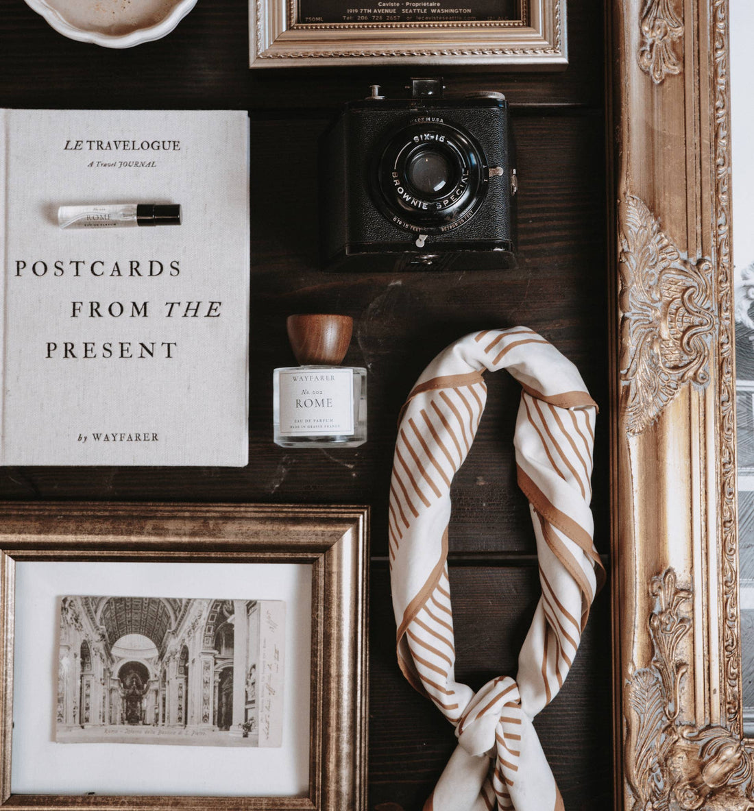 Postcards from the Present travel journal by Wayfarer, light linen cover, flat lay with small perfume sample and vintage…