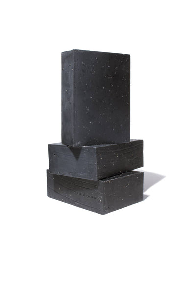 
                    
                      Charcoal Soap bar, dark gray speckled, stack of three rectangular bars with side texture detail, on white.
                    
                  