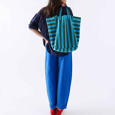 
                    
                      Elisabeth tote bag with turquoise and olive green vertical stripes, 100% cotton, carried over shoulder, back view for scale.
                    
                  