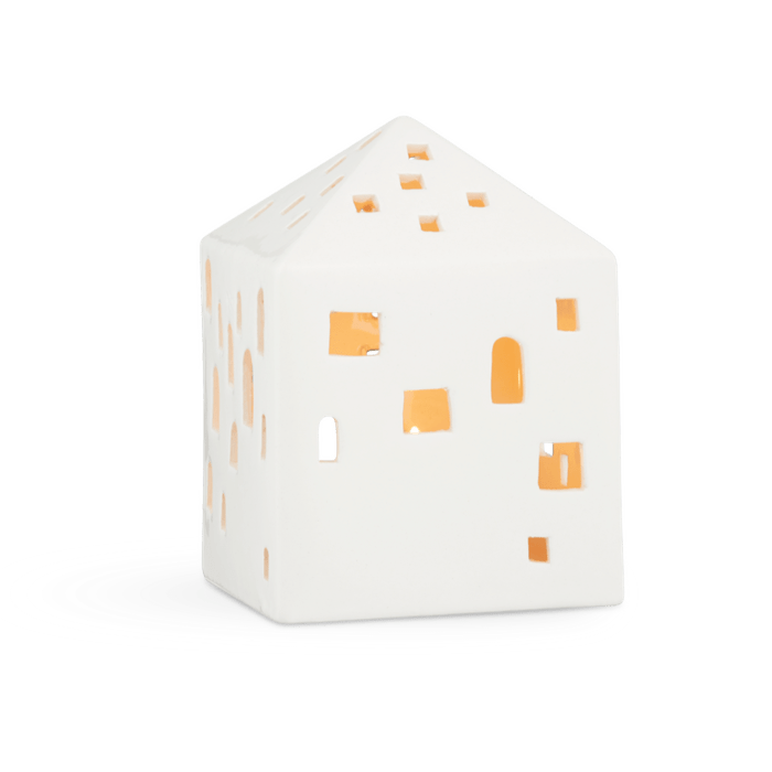 Danish Design Collective Urbania Lighthouse Town House white ceramic candle holder, front view on white with warm glow.