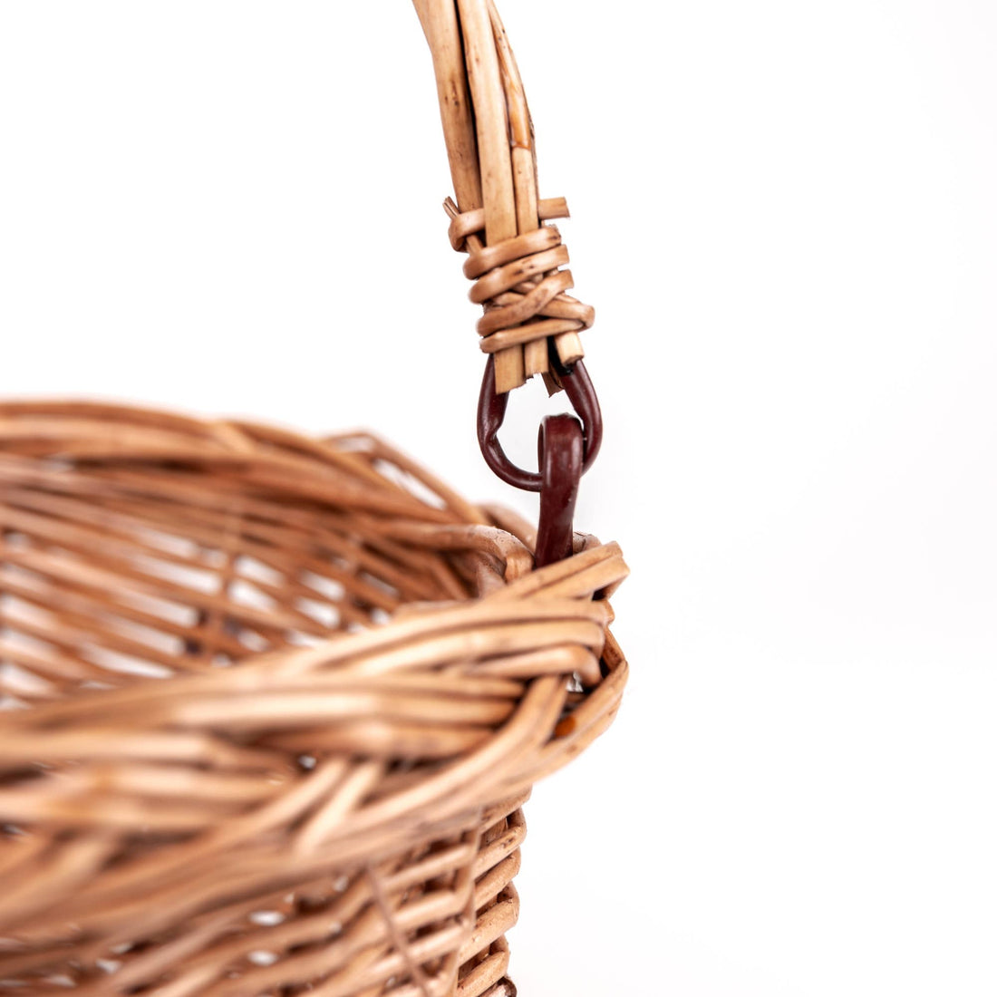 Wicker Bicycle Basket, close-up of natural rattan weaving and dark brown handle hook attachment