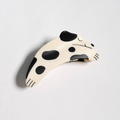 
                    
                      Puppy Claw Spotted Dog hair clip, black and white matte cellulose acetate, angled side view showing spotted pattern and clip…
                    
                  