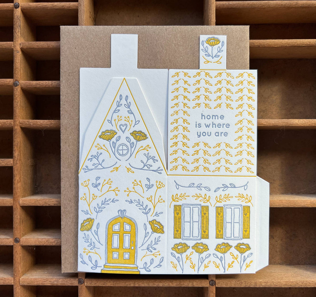 Home Is Where You Are 3D Die-Cut House greeting card, white cotton with yellow and blue letterpress floral illustrations,…