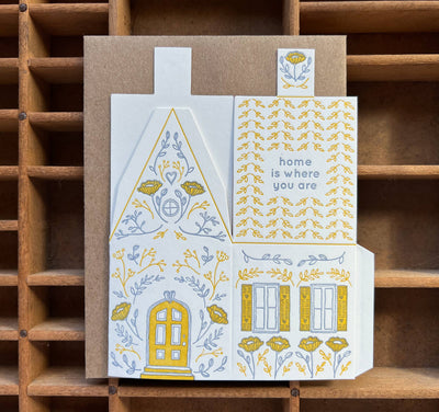 
                    
                      Home Is Where You Are 3D Die-Cut House greeting card, white cotton with yellow and blue letterpress floral illustrations,…
                    
                  