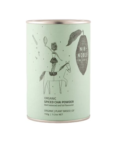 
                    
                      Nib + Noble Organic Spiced Chai Powder, light mint green tin with whimsical illustration, front view on white.
                    
                  
