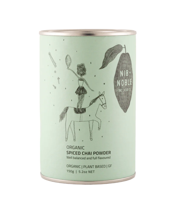 Nib + Noble Organic Spiced Chai Powder, light mint green tin with whimsical illustration, front view on white.