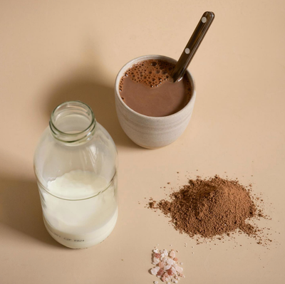 
                    
                      Organic Spiced Chai Powder, ingredients flat lay: loose brown powder, milk bottle, warm chai in ceramic mug with spoon, pink…
                    
                  