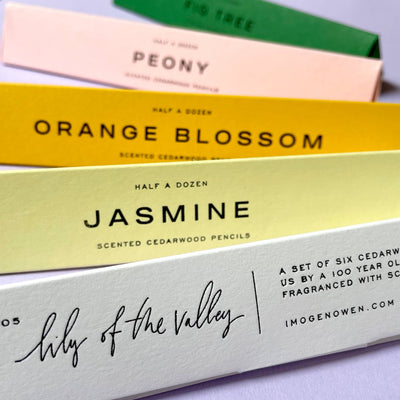 
                    
                      Orange Blossom scented cedarwood writing pencils, yellow box, close-up with Jasmine and Lily of the Valley boxes showing.
                    
                  