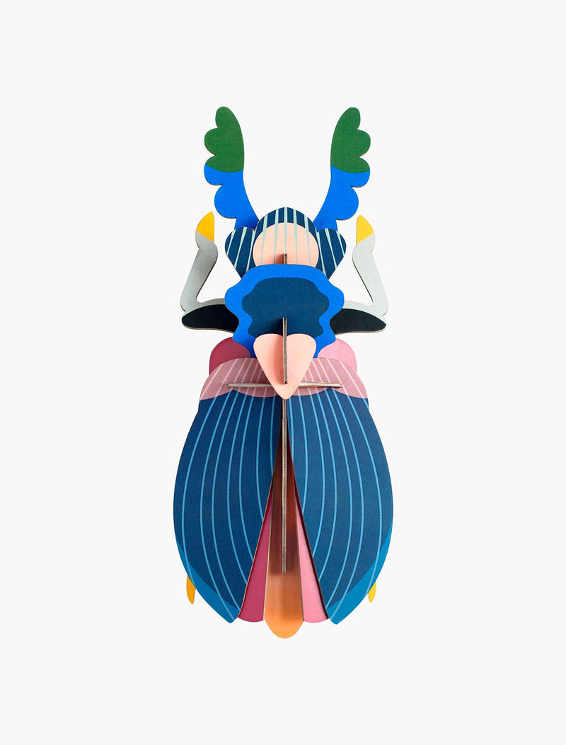 Studio Roof 3D Japanese Beetle craft kit, multicolored recycled cardboard with striped wings, front view on white.
