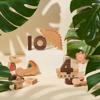 
                    
                      Numbers Play Block Set, natural beech and walnut wood. Number 10, a red-spiked dinosaur, rainbow, and various learning…
                    
                  