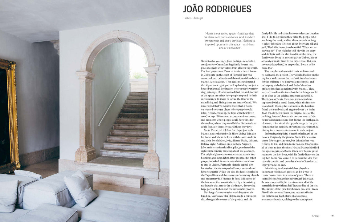Still: The Slow Home book, interior page featuring light stone arched doorway, a rustic staircase, gold-framed art, and…