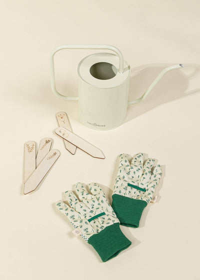 
                    
                      Gardening Tools Playset for kids, light green metal watering can, green patterned gloves, and wood plant markers, flat lay…
                    
                  