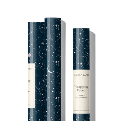 
                    
                      Red Cap Cards Moon and Stars wrapping paper, dark blue with white moon and star pattern, three rolls standing upright,…
                    
                  