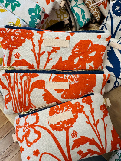 
                    
                      Erin Flett Laura Pouch, Flaggy Meadow orange floral cotton barkcloth, close-up of brass zipper and leather tag on stacked…
                    
                  