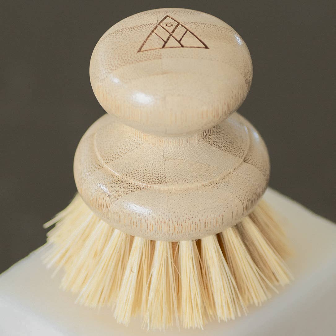 Casa Agave Dish Washing Brush, Moso bamboo handle close-up with geometric logo, natural agave fiber bristles.