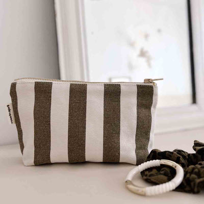 
                    
                      Rose in April Sofia Pouch, olive and white striped cotton canvas, brass zipper pull, angled close-up view showing brand tag.
                    
                  