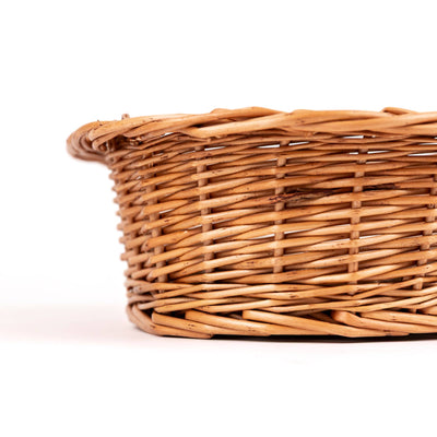 
                    
                      Wicker Dog Basket, natural woven willow, close-up side view showing the detailed weave pattern.
                    
                  