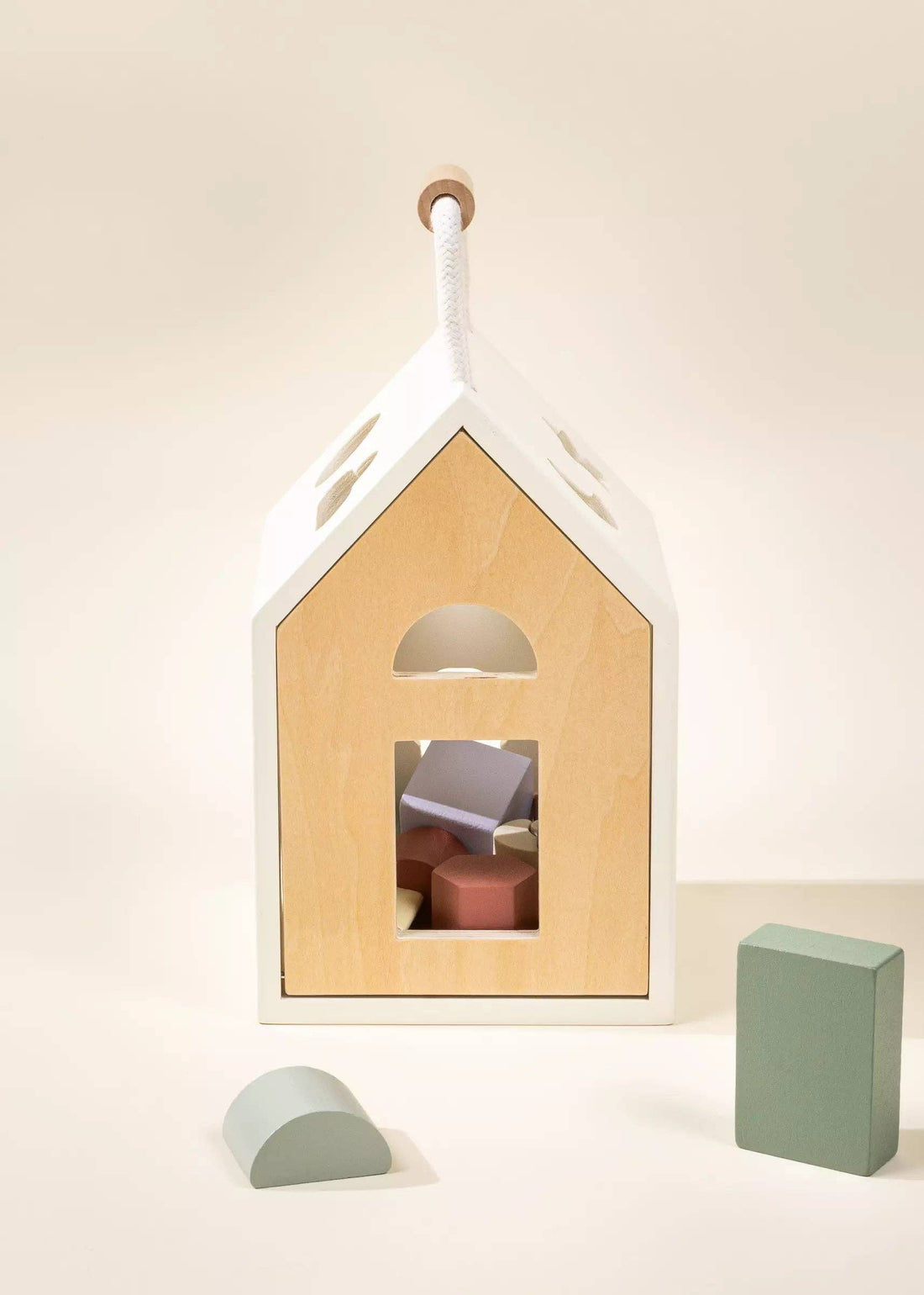 Wooden Shapes Sorting House, natural wood front, white frame, rope handle, sage green rectangle, light blue arch block