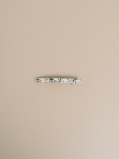 
                    
                      Coco Cream hair clip, cream and dark marbled cellulose acetate, flat lay showing metal barrette clip.
                    
                  