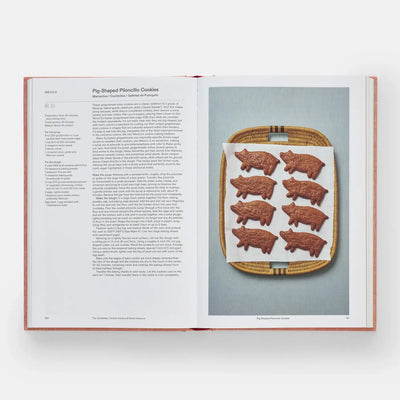 
                    
                      Crumbs: Cookies and Sweets cookbook, open to Pig-Shaped Piloncillo Cookies recipe page, showing brown cookies in a basket.
                    
                  