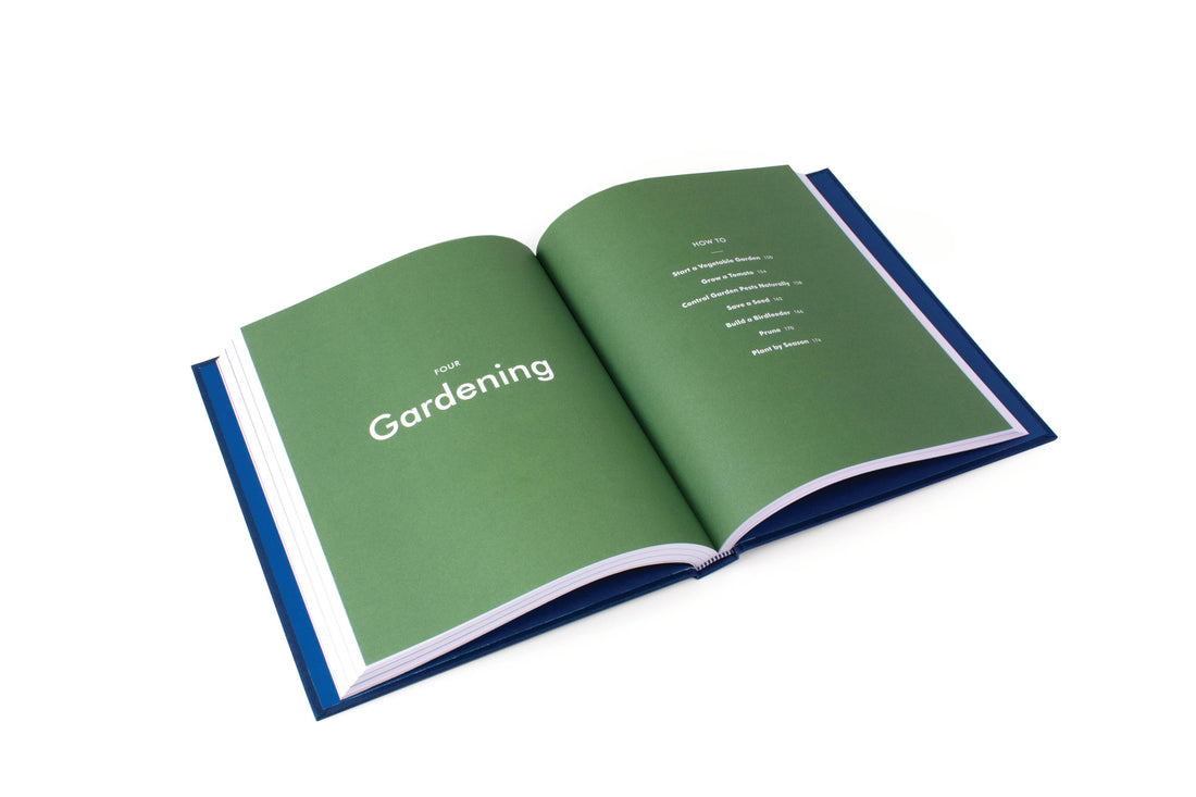 The Kaufmann Mercantile Guide print book, open to the green 'Gardening' chapter and contents list, showing blue cover.