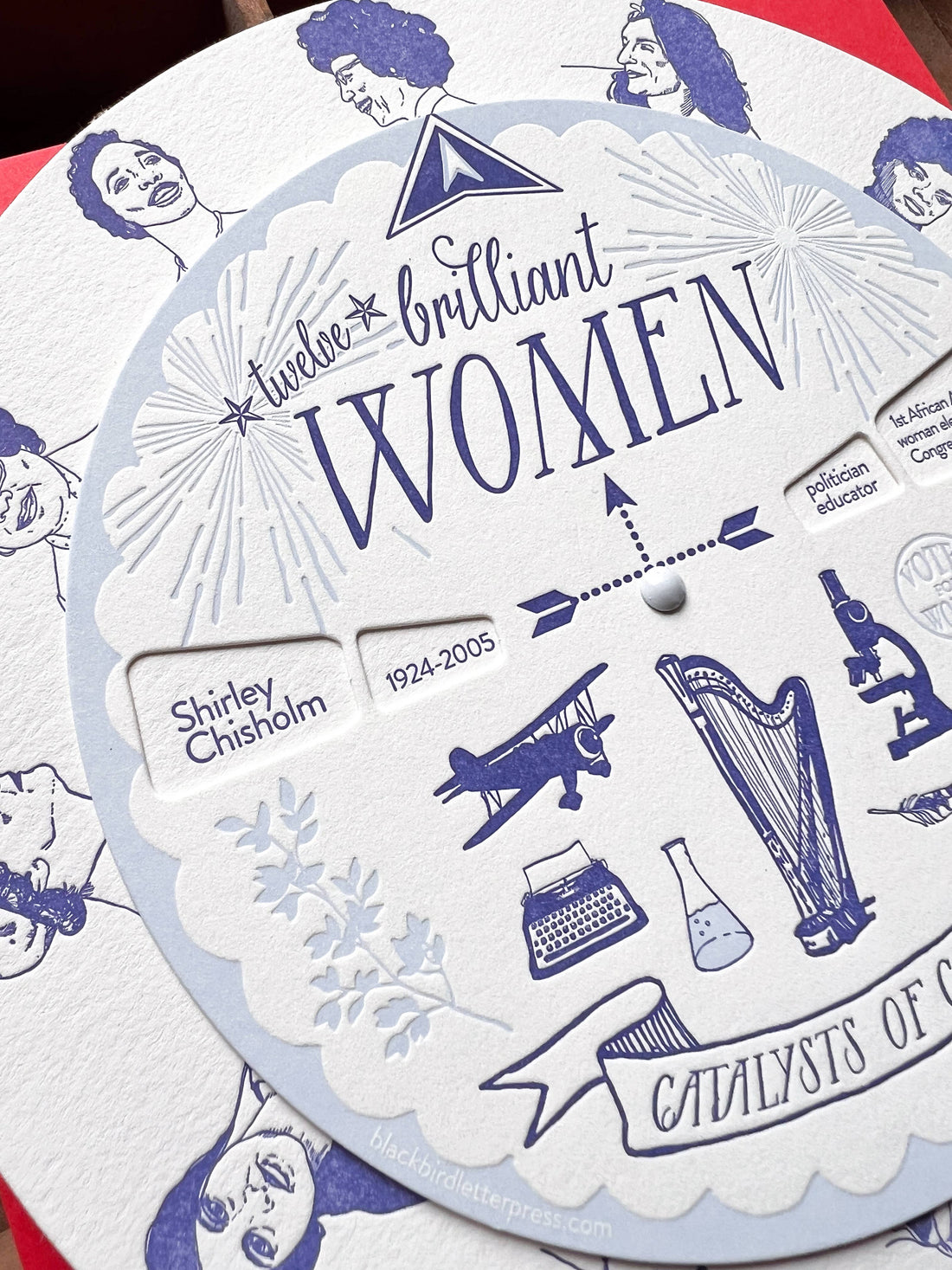 Brilliant Women Spinner, cotton paper, close-up of blue letterpress revealing Shirley Chisholm, biplane, harp, microscope.