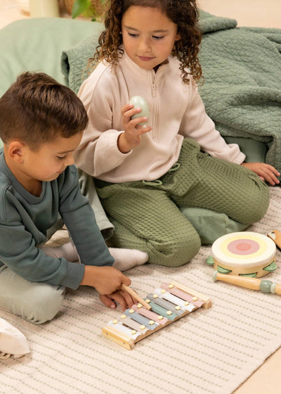 
                    
                      Wooden Musical Instruments Playset, two kids playing with wood xylophone, tambourine, and pastel egg shaker.
                    
                  