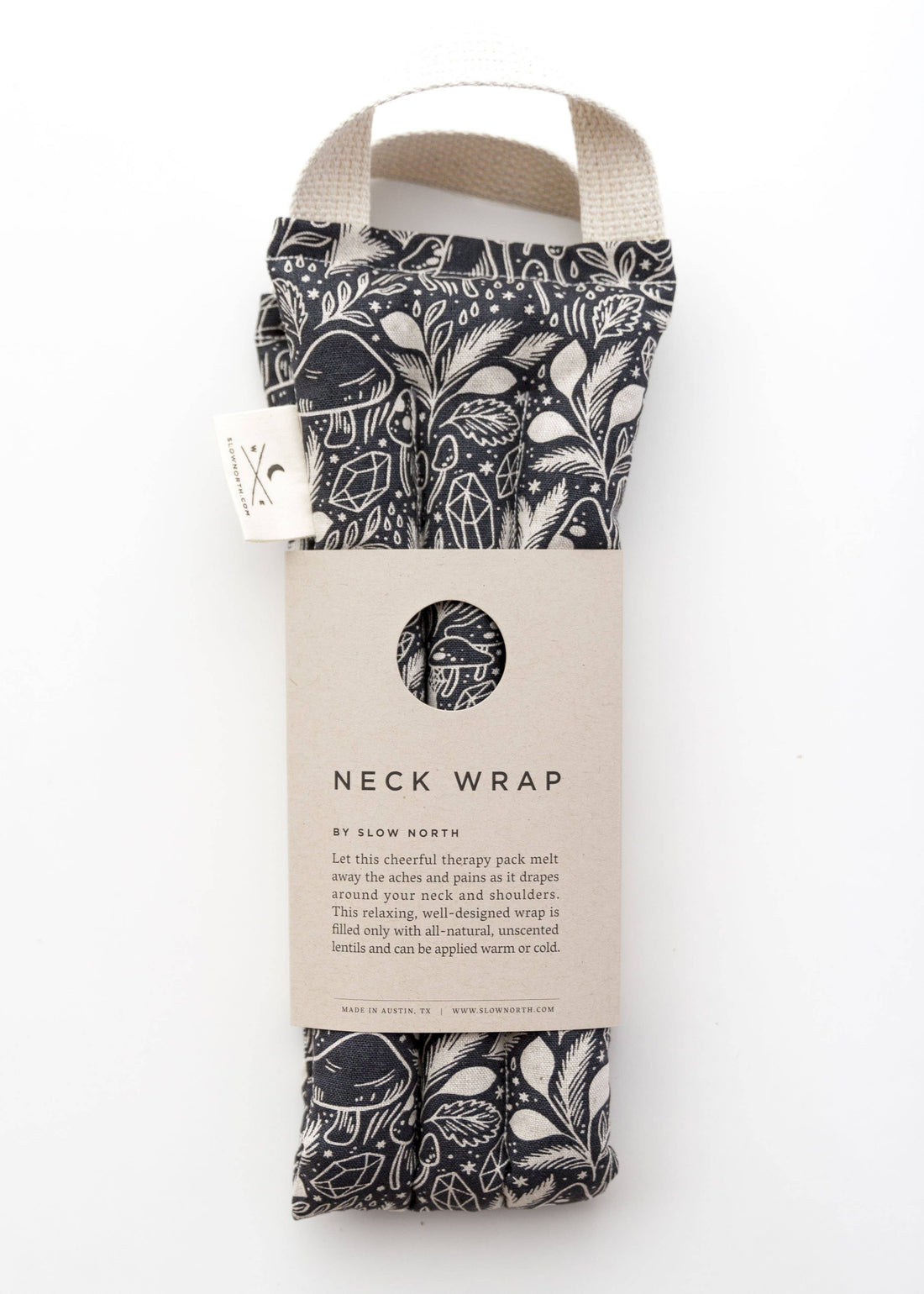 Slow North Microwaveable Neck Wrap, Mystical Print, black & white patterned fabric in package with brand tag, standing…