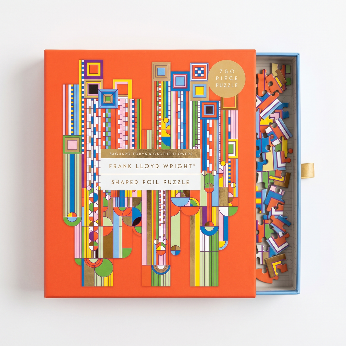 Chronicle Books FLW Saguaro Forms foil puzzle, orange box with geometric pattern, lid open revealing pieces.