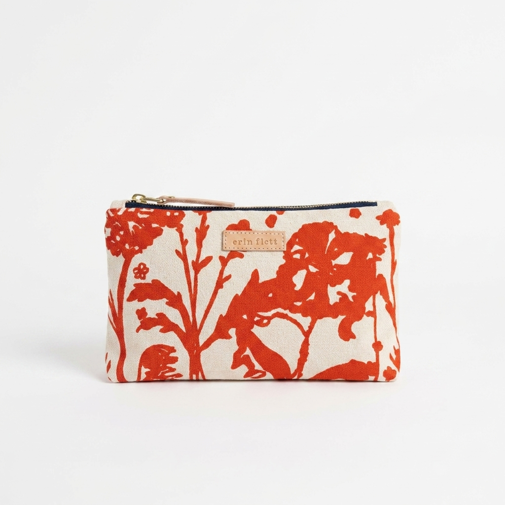 Erin Flett Laura Pouch - (Flaggy Meadow) studio product photo hanging from a wooden wall hook on a neutral off-white…