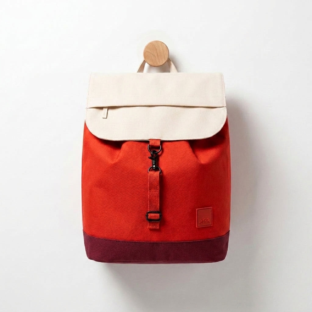 Lefrik Kaut Backpack Cherry Block studio product photo hanging from a wooden wall hook on a neutral off-white background