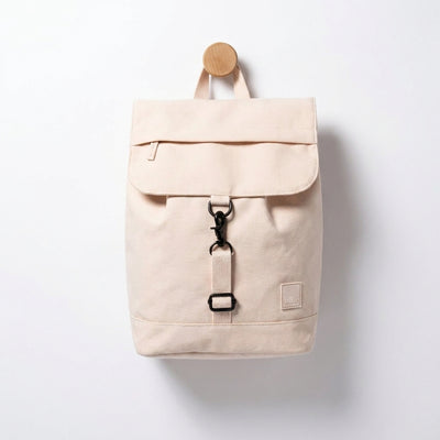 
                    
                      Lefrik Kaut Mini ecru backpack, Oxford RPET fabric, hanging on a wood peg, black clip closure, front view.
                    
                  