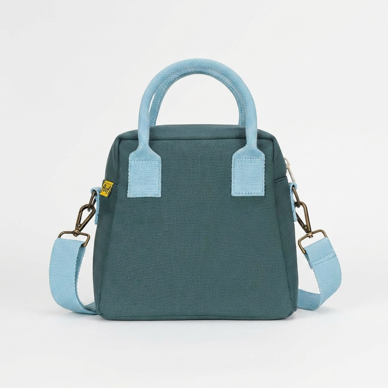 Fluf Lunch Clutch - Cypress studio product photo hanging from a wooden wall hook on a neutral off-white background