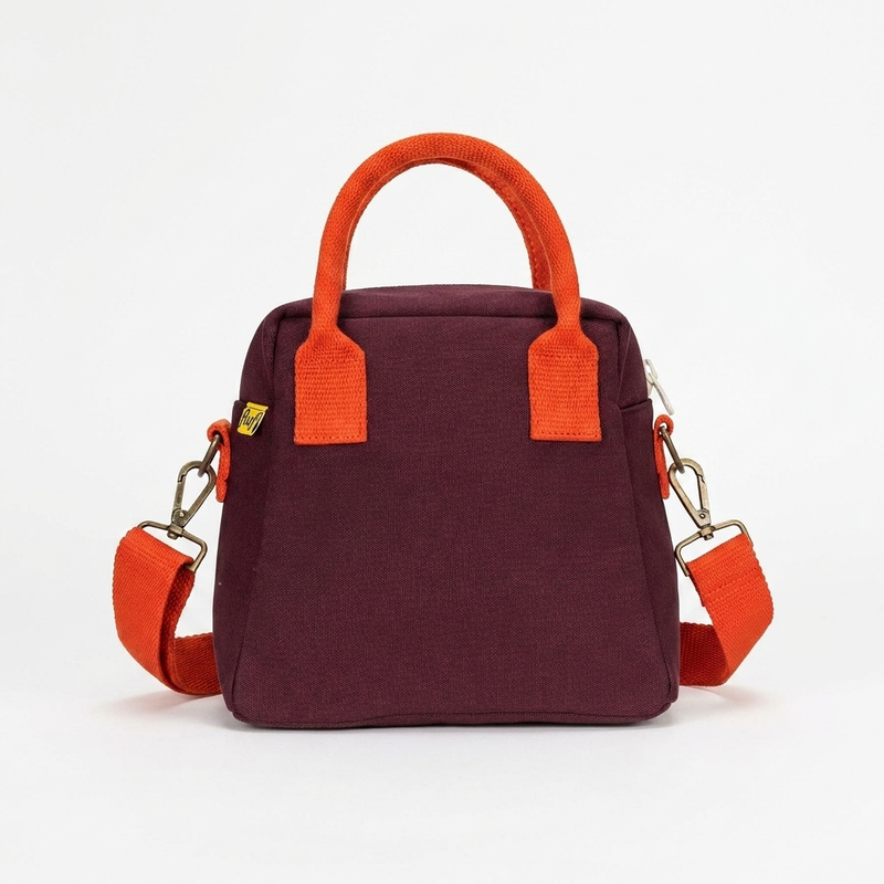 Fluf Lunch Clutch - Fig studio product photo hanging from a wooden wall hook on a neutral off-white background