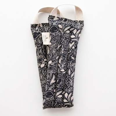 
                    
                      Slow North Microwaveable Neck Wrap, Mystical Print, black fabric with off-white mushrooms and crystals, front flat lay on…
                    
                  