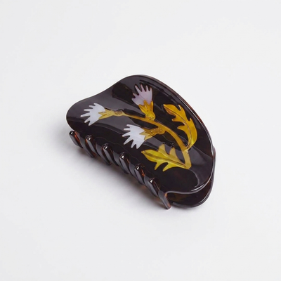 
                    
                      Winona Irene Milk Thistle Hair Claw, dark tortoise cellulose acetate with yellow and lavender floral design, angled view on…
                    
                  