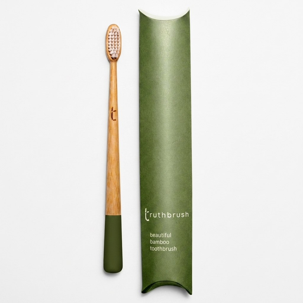 Truthbrush Moss Green Bamboo Toothbrush, natural bamboo handle with moss green base, white bristles, flat lay with green…